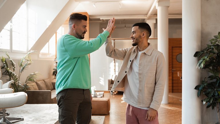 Two men giving high five