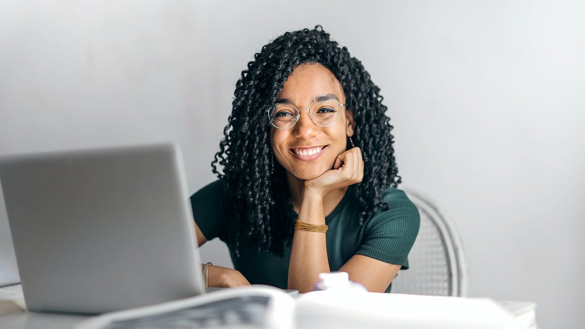 Woman sitting at her desk with a smile