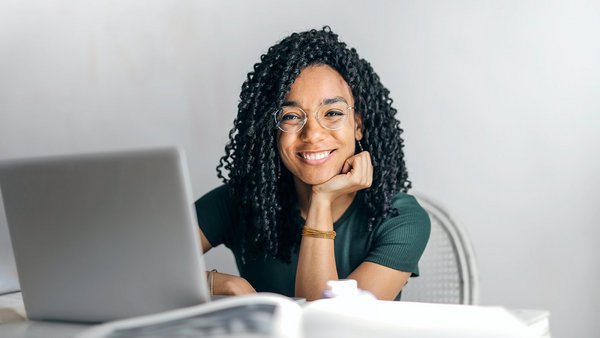 Woman sitting at her desk with a smile