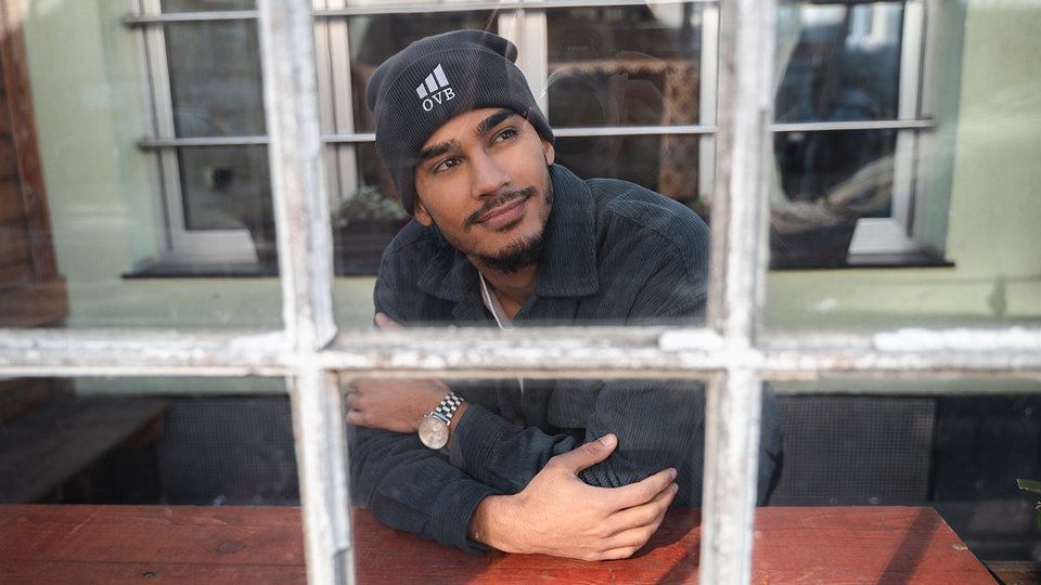 Man looking through a window