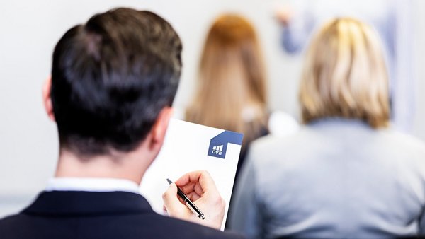What exactly is professional development? Employee in a professional training course takes notes