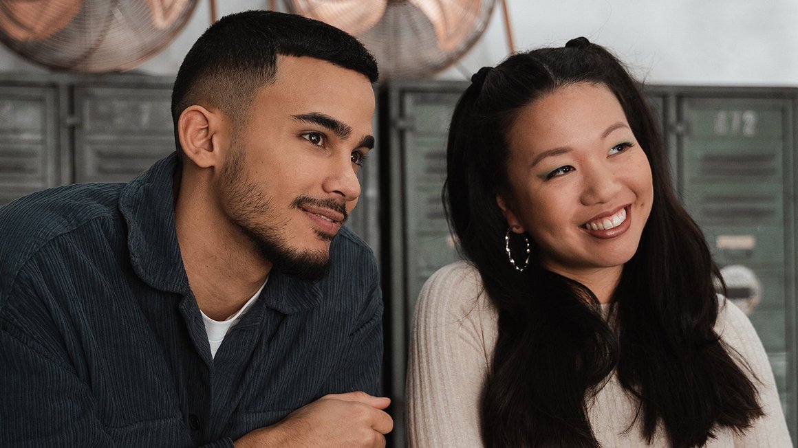 Man and woman standing next to each other smiling