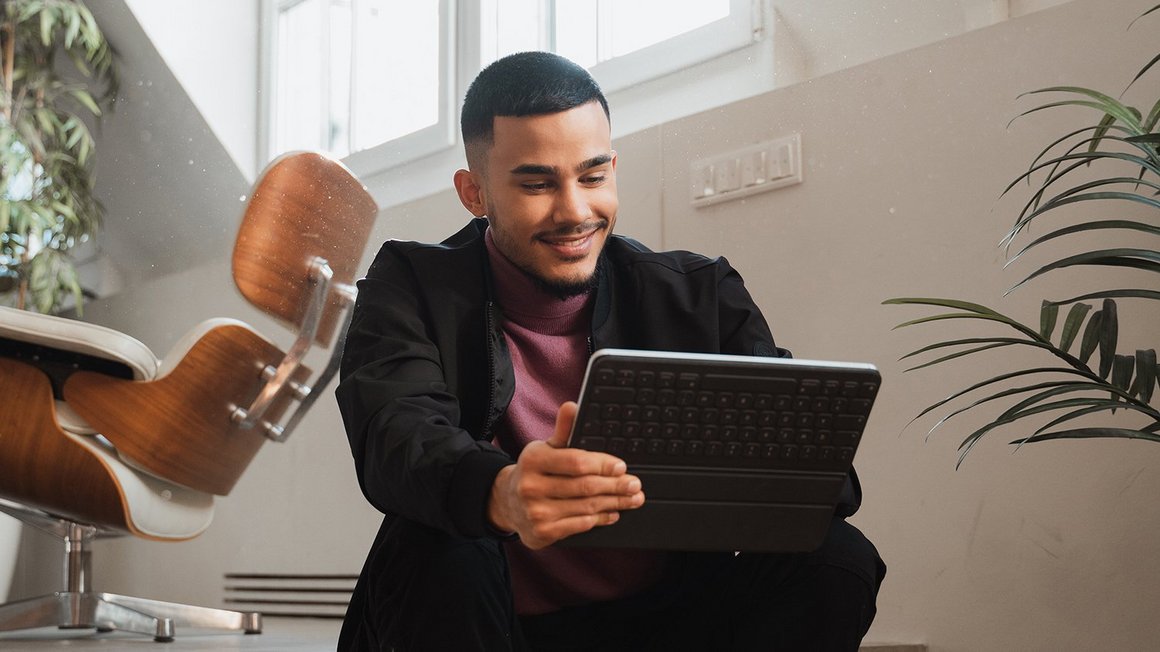 Man looking at laptop with a smile