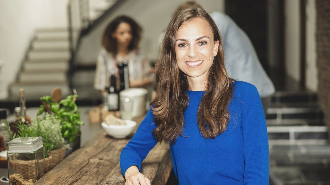 Woman sitting in a restaurant for her lunch routine, laughing