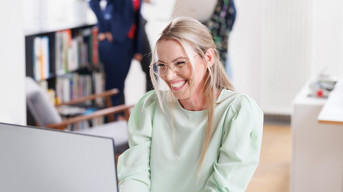 Employee does professional development on her notebook and laughs