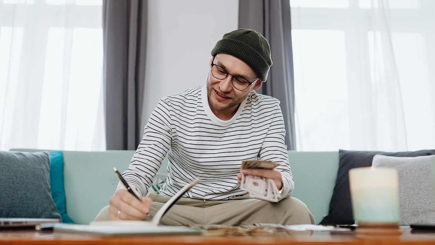 A man sits at a table and counts money A man sits at a table and counts money