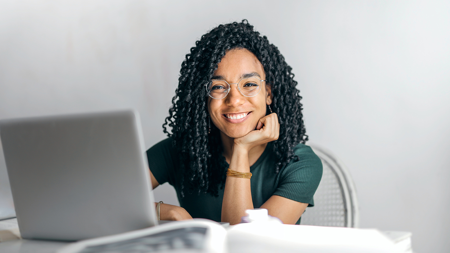 Woman sitting at her desk with a smile Woman sitting at her desk with a smile
