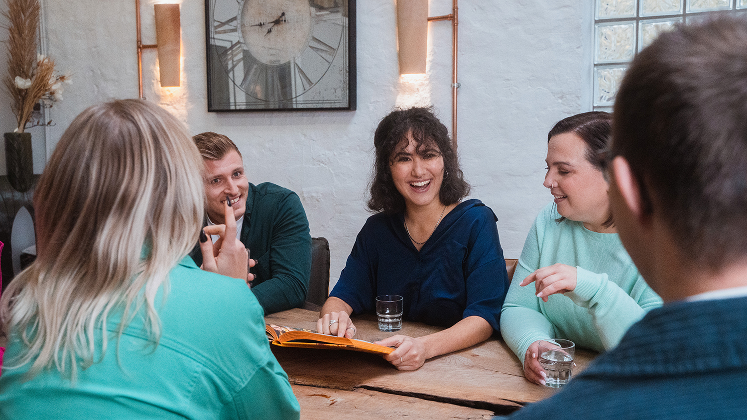 The top 5 work trends in 2025 Team sits together in a meeting laughing