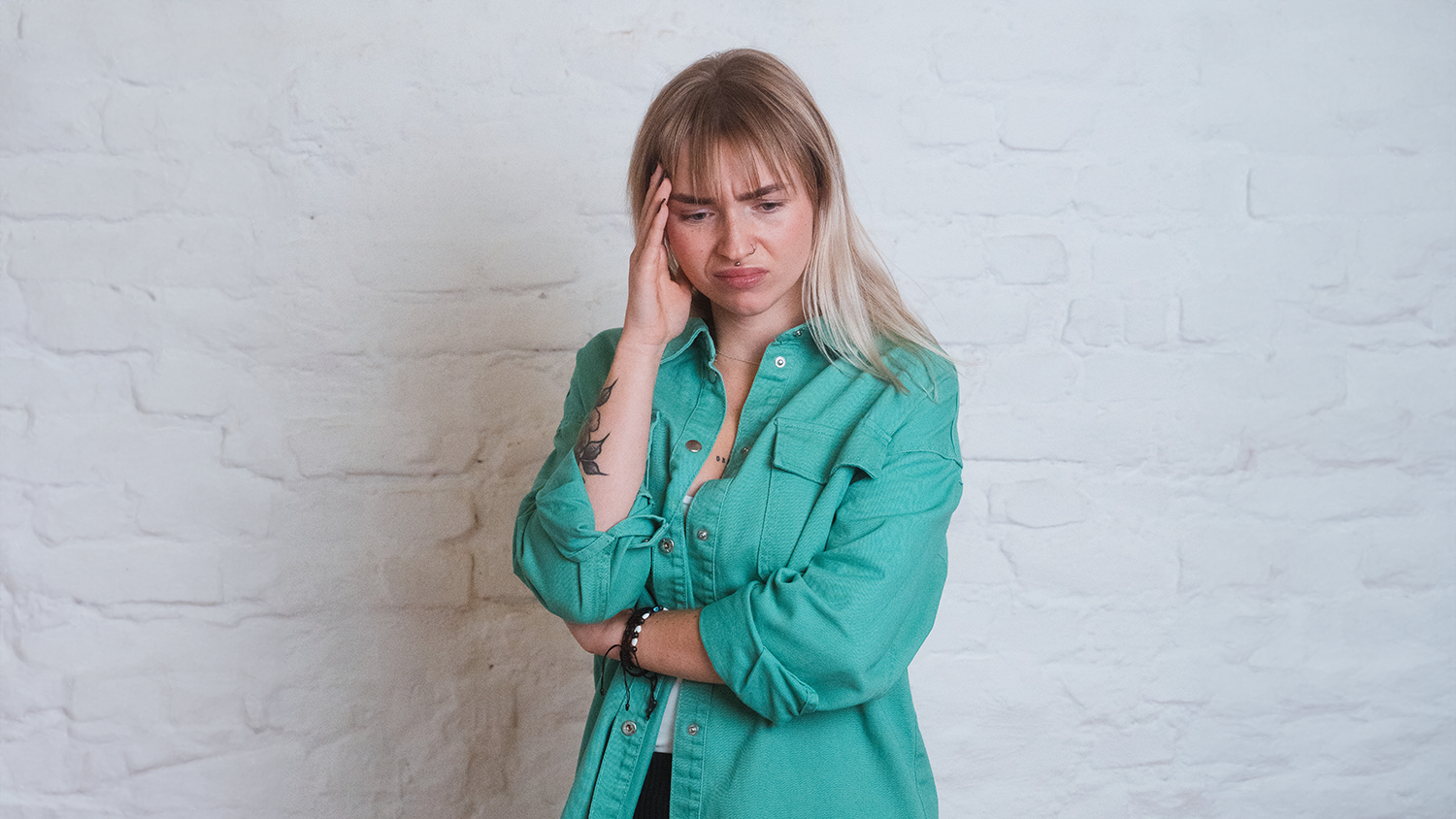 Woman places her hand on her head