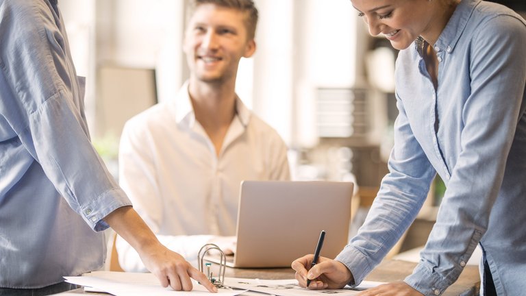Young man with tablet smiles