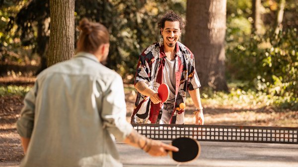 Kollegen spielen Tischtennis nach der Arbeit – New Work bei OVB Holding Kollegen spielen Tischtennis nach der Arbeit – New Work bei OVB Holding