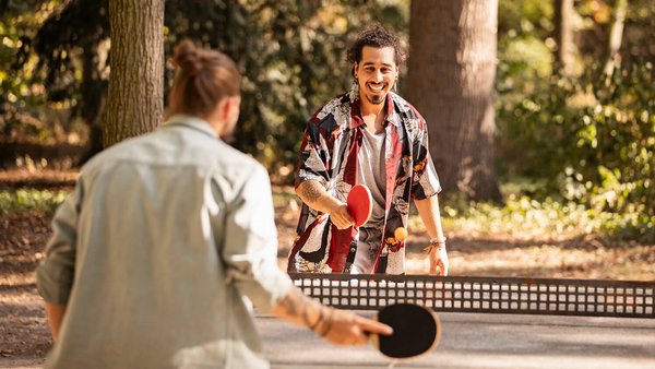 Colleagues play table tennis after work - New Work at OVB Holding