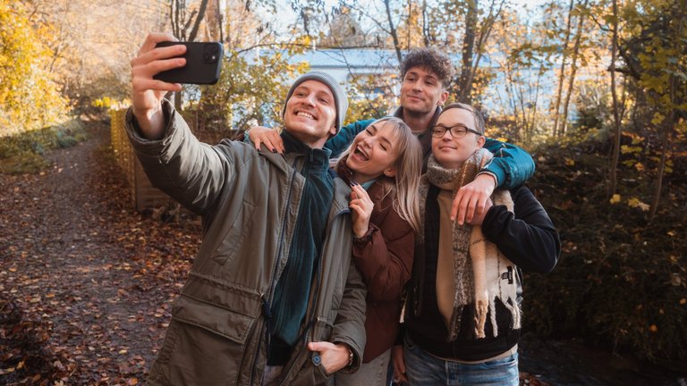 A group of young people taking a selfie in the park